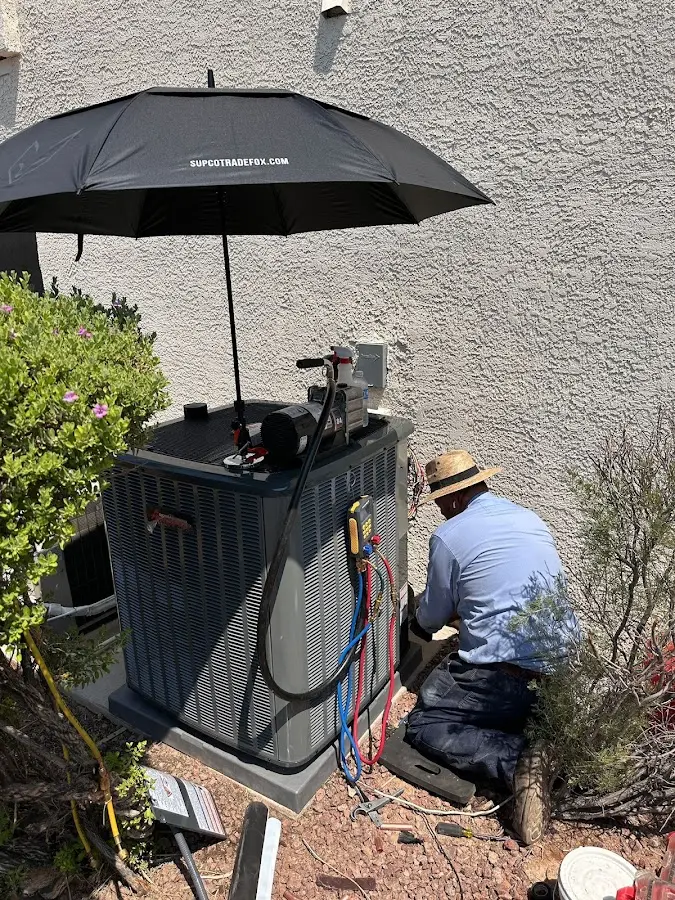 HVAC technician performing outdoor AC maintenance in Dock Junction