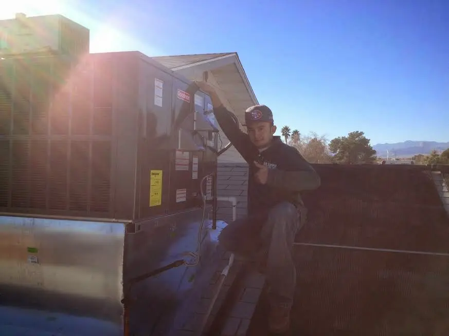 HVAC technician performing AC Tune-Up on a rooftop unit in Dock Junction